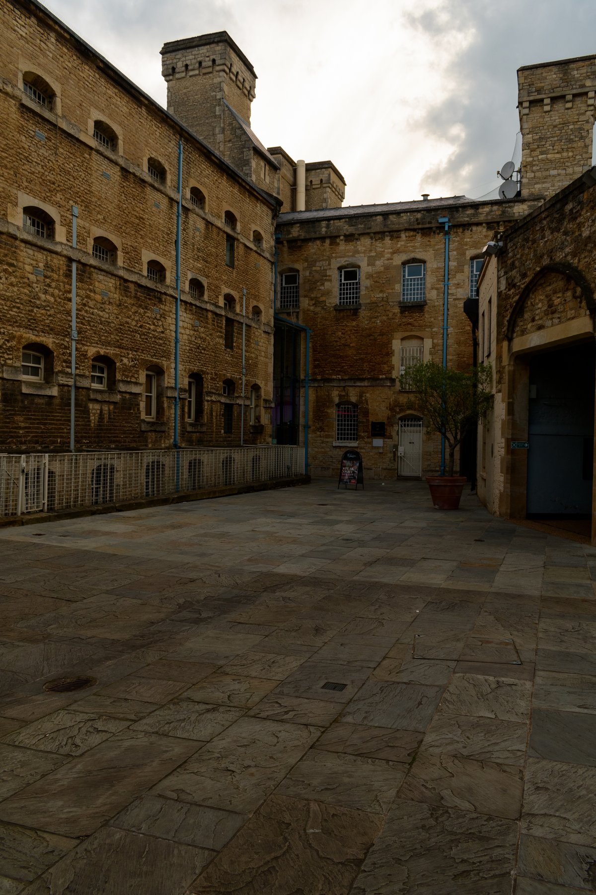 Front range of former prison building at Oxford Castle with entrance, wing, and former chapel