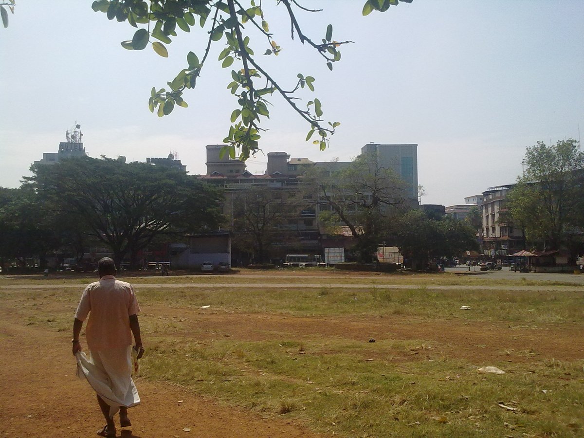 Skyline of Thrissur city viewed from Thekkinkadu Maidan with urban buildings and clear sky