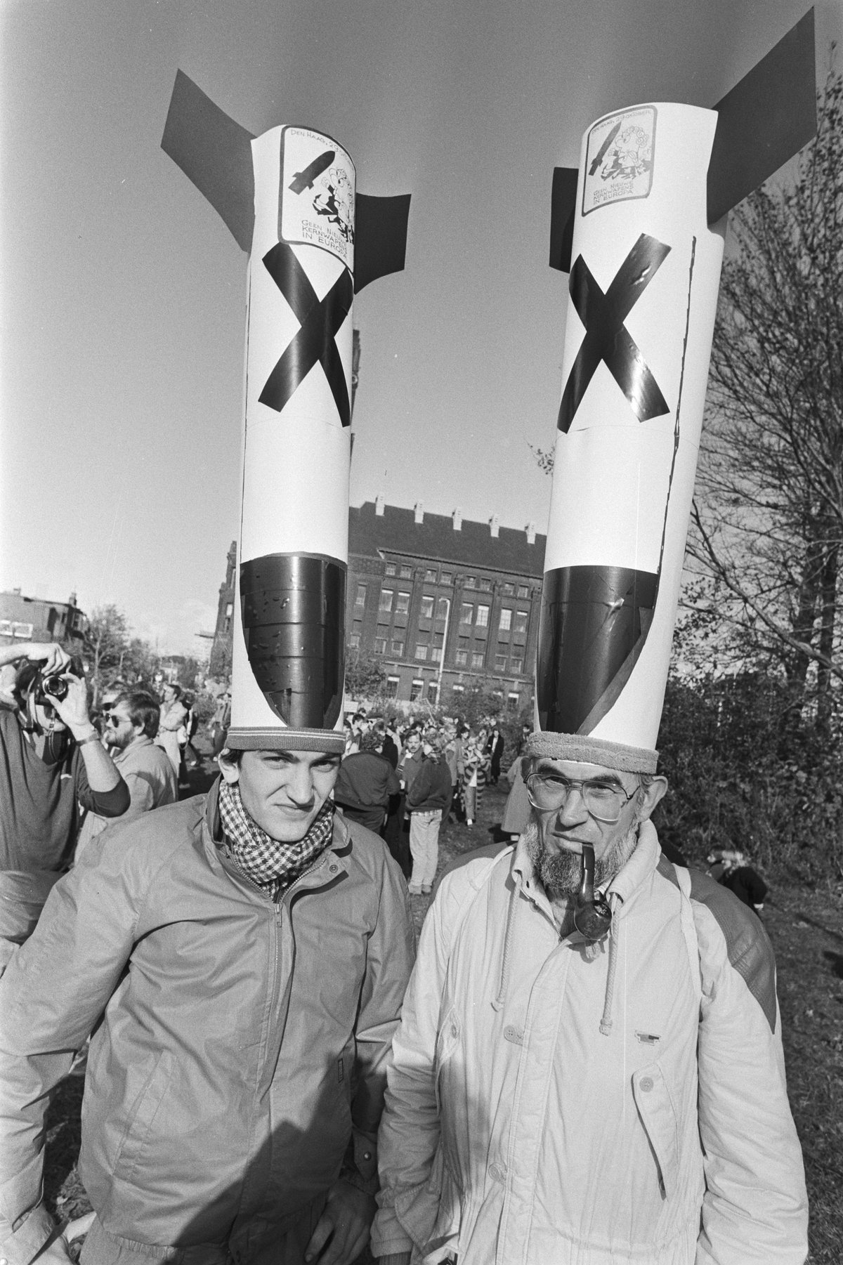 Two demonstrators at The Hague protest against cruise missiles wearing cardboard nuclear missiles on their heads
