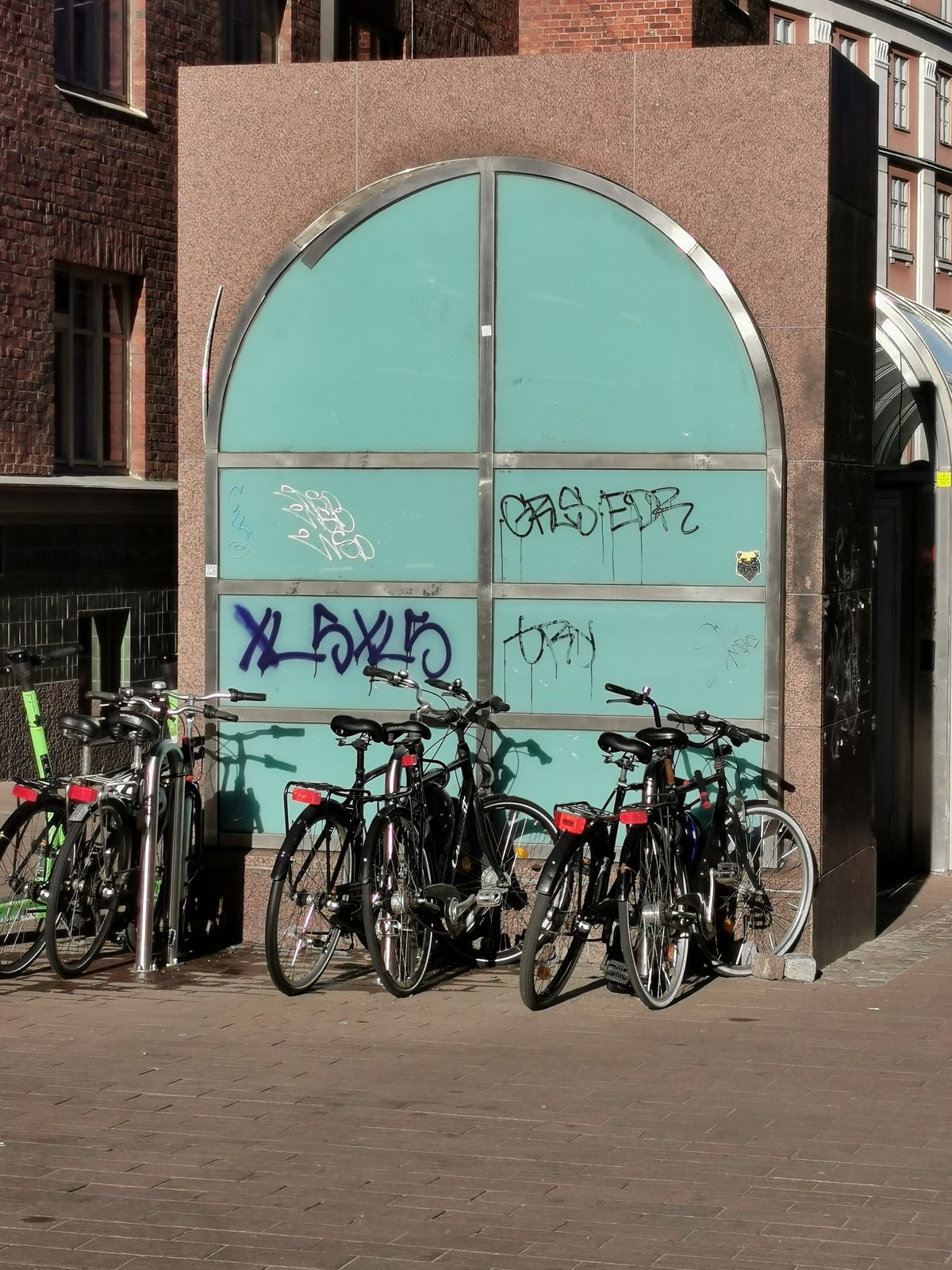 Bicycles parked at Vuorikatu street near Helsinki University metro station entrance