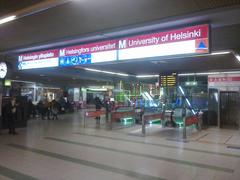University of Helsinki metro station platform with train and passengers