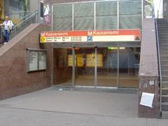 Kaisaniemi Metro Station entrance in Helsinki with modern glass and steel architecture and people walking