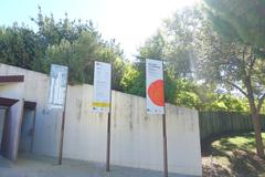 Entrance of Botanical Garden of Barcelona with greenery and Montjuïc hill in background