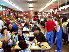 Interior of Katz's Delicatessen with red booths and tables