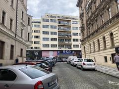 View of a modern cinema building named Bio Oko in Prague from Vltavská Street with trees and a street scene