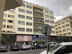 Scenic view from Vltavská to Bio Oko theater in Prague with modern buildings and greenery