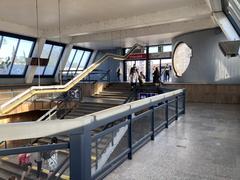 Vltavská metro station platform with train and passengers