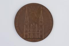 Medal showing the neogothic Saint-Ambroise church with an angelic figure holding the church plan in the sky, commemorating its inauguration on November 11, 1869