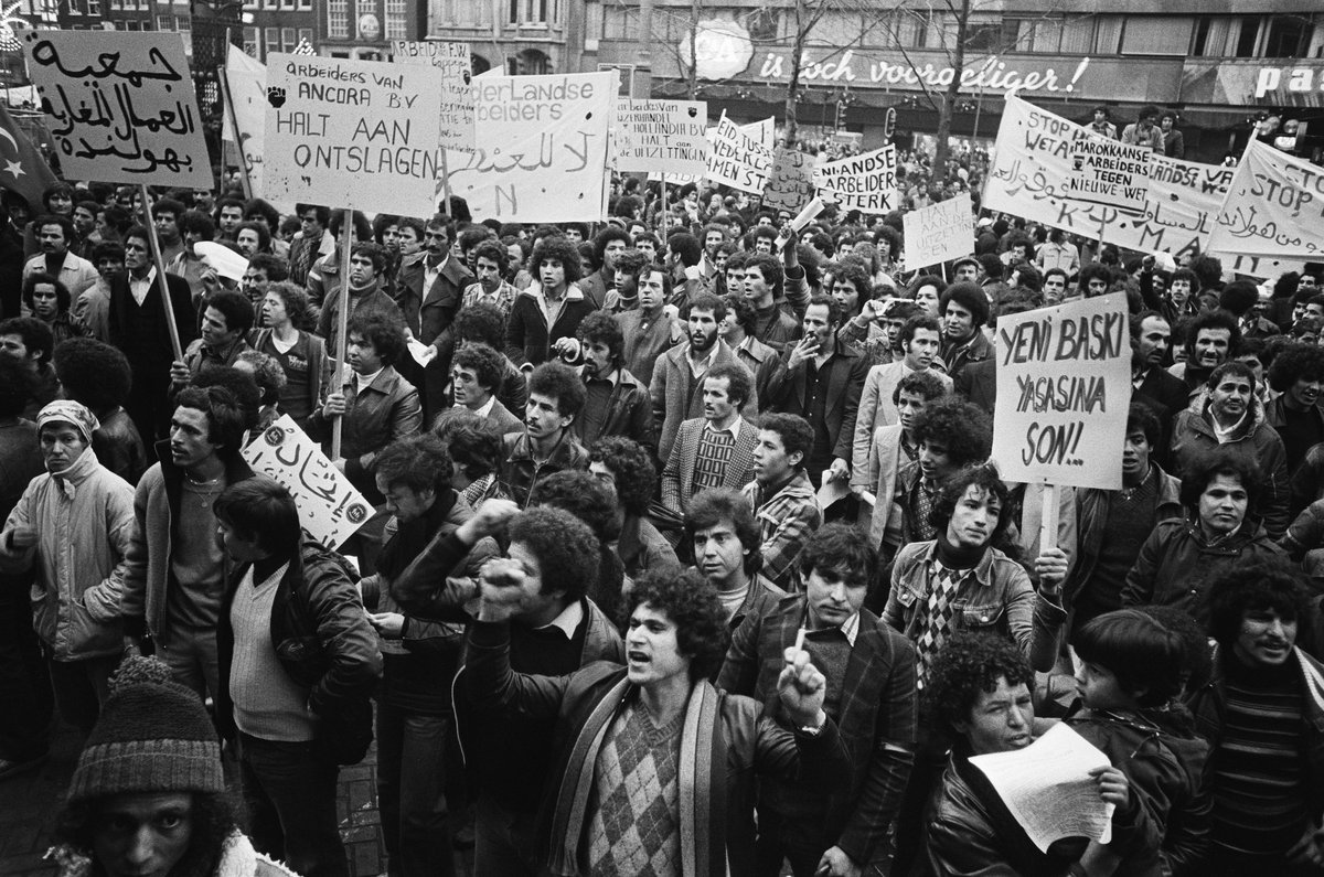 Demonstrators gathered at Beursplein in Amsterdam with banners protesting new 1979 Foreign Workers Labor Law
