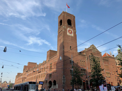 Beurs van Berlage building on the Damrak street in central Amsterdam with people walking in front on a sunny day