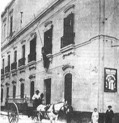 Early 20th century university building with red-tiled roof and classical architecture