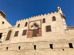 Luxor Temple in the city of Luxor, Egypt, showing ancient Egyptian architecture with stone columns and ruins under a bright blue sky
