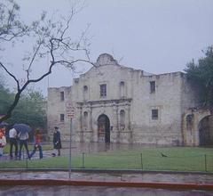 Alamo Mission in San Antonio on a rainy day with wet pavement and overcast sky