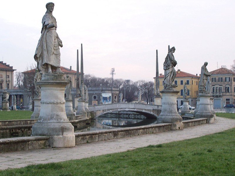 View of Prato della Valle square in Padova, Italy with historic buildings and a large elliptical green space