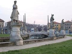 View of Prato della Valle square in Padova, Italy with historic buildings and a large elliptical green space
