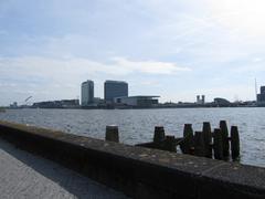 IJ bay in Amsterdam with the Muziekgebouw concert hall, Passagiers Terminal, Jan Schaeferbrug bridge, and NEMO Science Centre