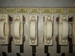 Close-up of a large vintage marble fuse board with multiple switches and labels