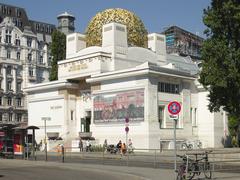 Front view of the Secession building in Vienna with golden dome and ornate architectural details