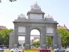 View of the historic Puerta de Toledo monument in Madrid under a vibrant blue sky