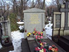 Grave on Olšany Cemeteries with stone monument and flowers