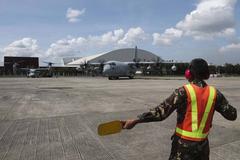 Philippine Air Force Sgt. Alex Deoric guiding a U.S. Marine Corps MV-22B Osprey tiltrotor aircraft at Villamor Air Base