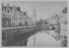 Black and white artistic image of city canal De Dijver in Bruges with the tower of Onze-Lieve-Vrouwekerk in the background