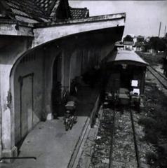 Vietnamese National Railroad station in Saigon with trains and people on the platform
