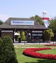 Entrance archway to Boudewijnpark in Brugge, Belgium surrounded by trees