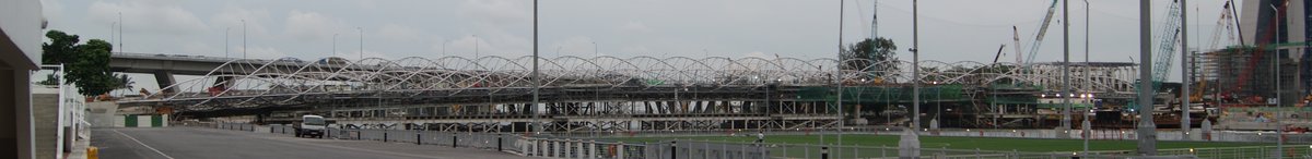 Panoramic view of the Double Helix Bridge in Singapore with its unique spiral design against a clear sky