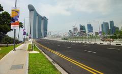Marina Bay Sands Hotel with Bayfront Avenue and The Helix Bridge at sunset in Singapore skyline