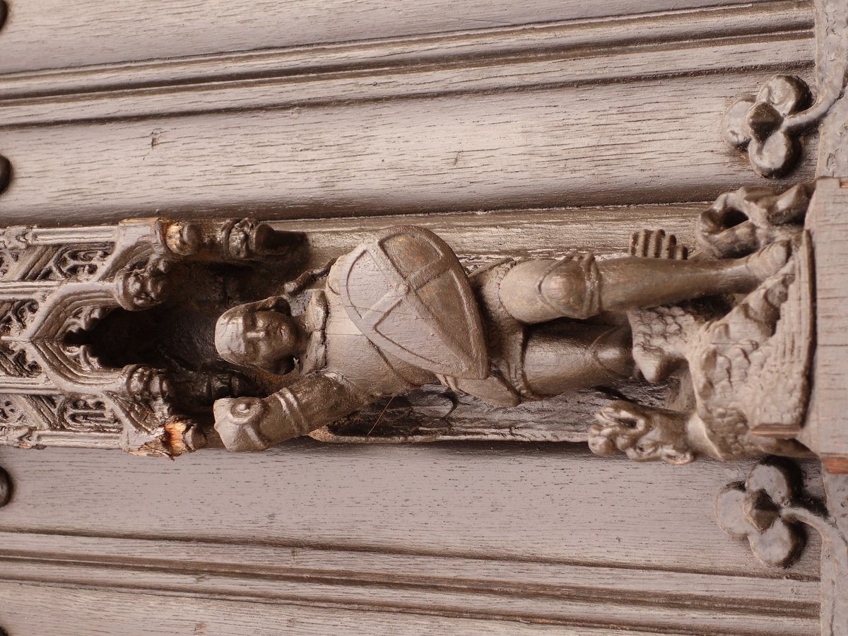 Bronze statuette of a soldier in an ornate door of Brussels Cathedral