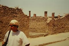 Ancient ruins in Pompeii with Mount Vesuvius in the background