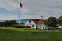 Historic Kommandantbolig building at Kristiansten Fortress in Trondheim under blue sky