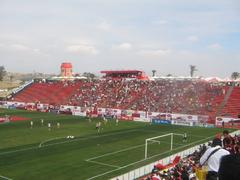 Estadio Caliente soccer stadium illuminated at night