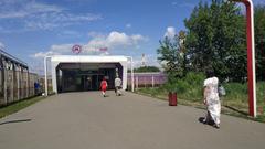 Andronovka train station with trains on tracks and overhead electrical wires