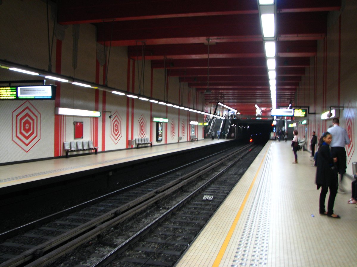 Interior of Metrostation IJzer with distinct modern architecture and yellow accents