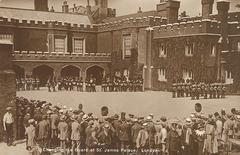 Changing the Guard ceremony at St. James Palace in London with guards in traditional red uniforms and bearskin hats