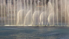 Fountains of Bellagio water show at night with illuminated jets and city skyline