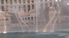 Fountains of Bellagio water show at night with illuminated jets and Bellagio Hotel in the background