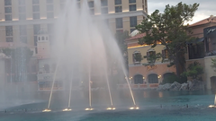 Fountains of Bellagio in action with water jets illuminated at night