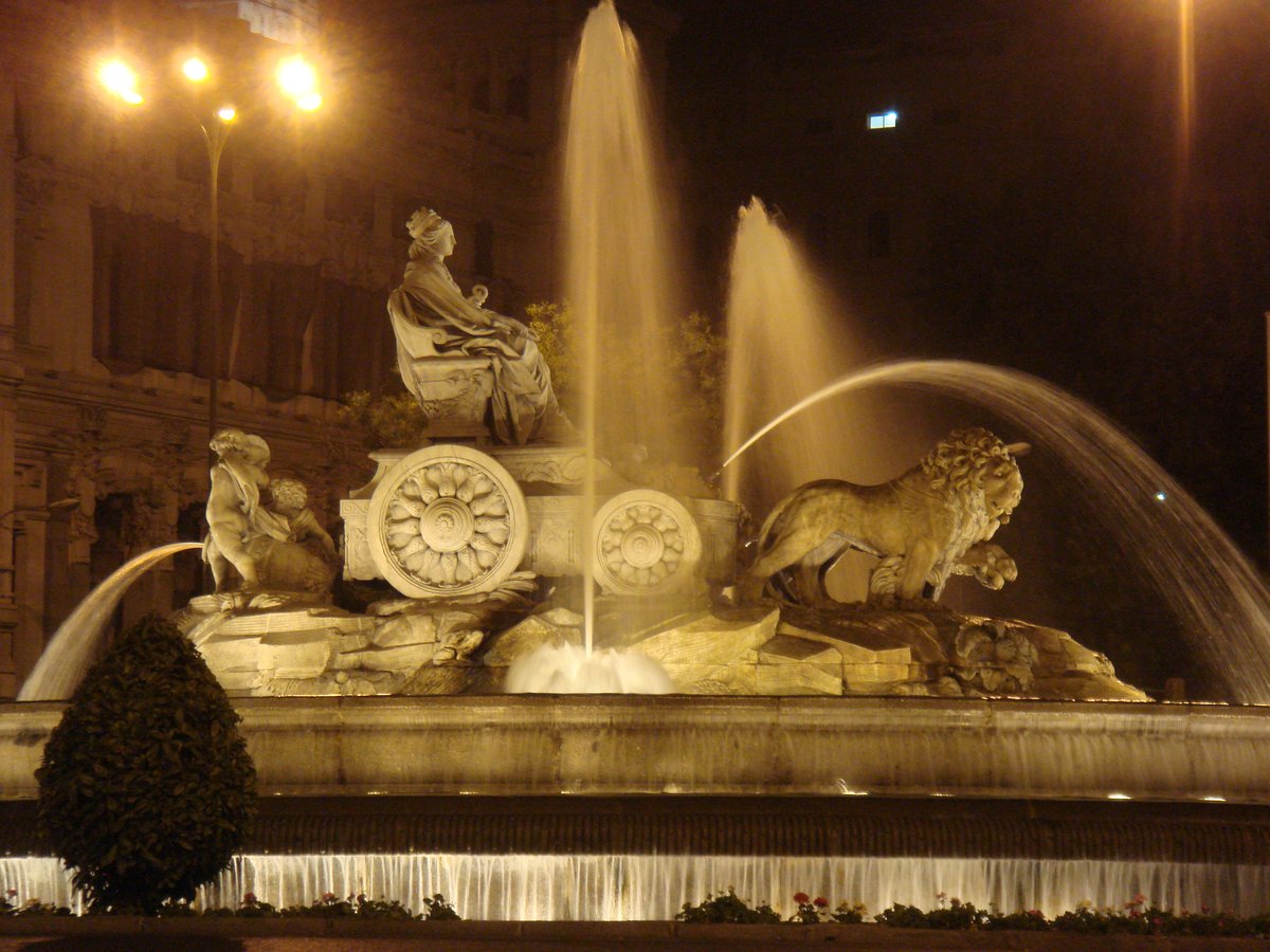 Fuente de la Cibeles in Madrid at night with illuminated fountain and beautiful sculptures
