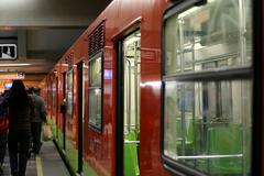 Interior of a Metro CDMX train with passengers seated and standing
