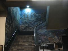 Mural on stairwell in Metro Tacubaya station, Mexico City, featuring colorful abstract and figurative designs
