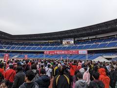 Waseda Ekiden relay race runners in rainy weather at Yokohama Nissan Stadium