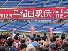 Waseda Ekiden team running in rainy weather at Yokohama Nissan Stadium