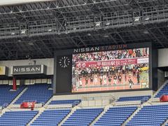 Teams running in a rainy Waseda Ekiden relay race at Yokohama Nissan Stadium
