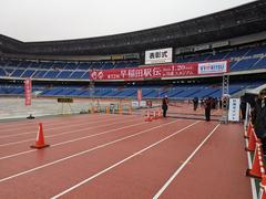 Waseda Ekiden running team competing in rainy weather at Yokohama Nissan Stadium