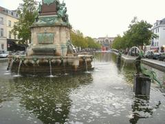 Anspach Fountain in Brussels, Belgium with a classical sculpture and surrounding greenery