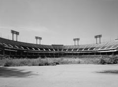 Abandoned Baltimore Memorial Stadium with faded seating and overgrown vegetation
