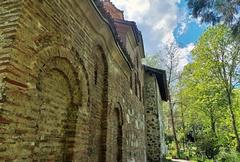 Boyana Church exterior with stone walls and green dome under blue sky